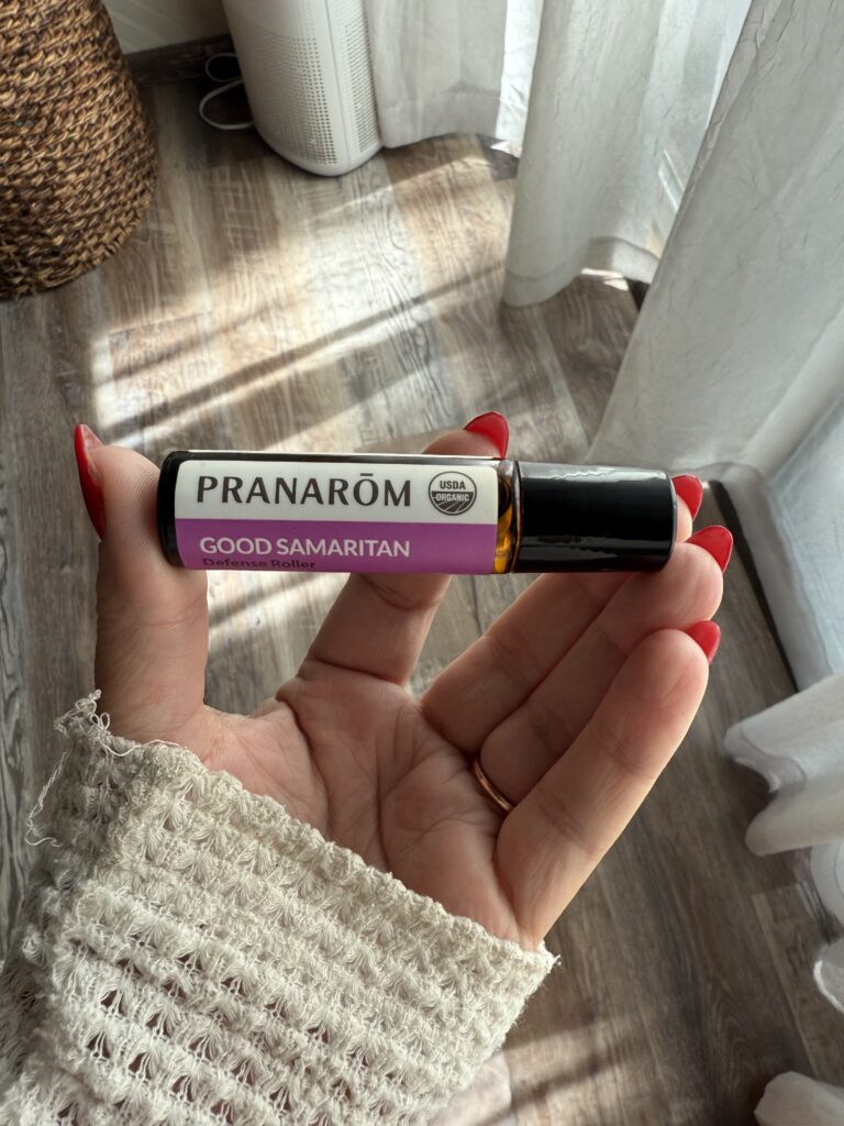 woman holding essential oil, pranarom good samaritan essential oil