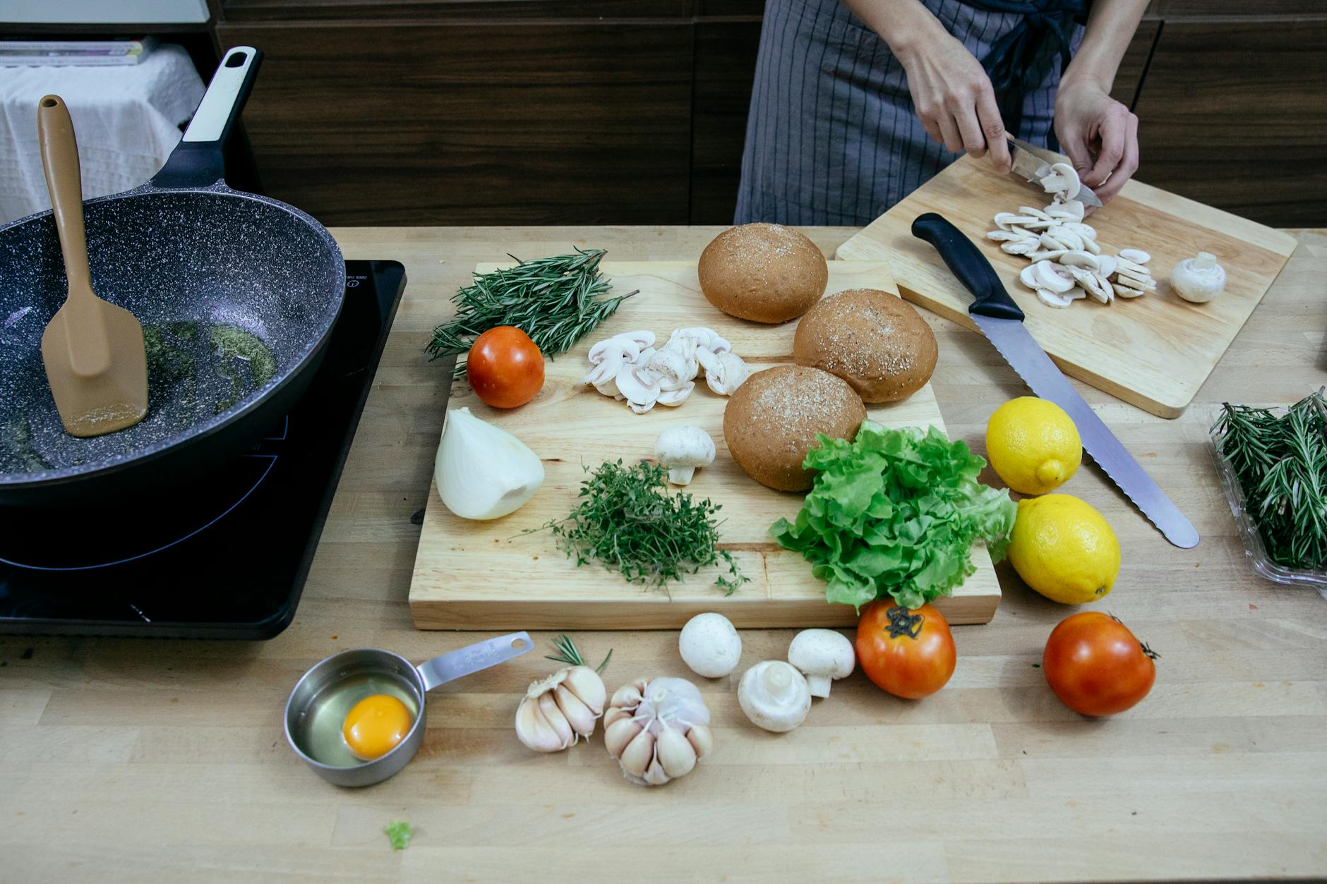 crop unrecognizable housewife cutting mushrooms while cooking vegetable stew