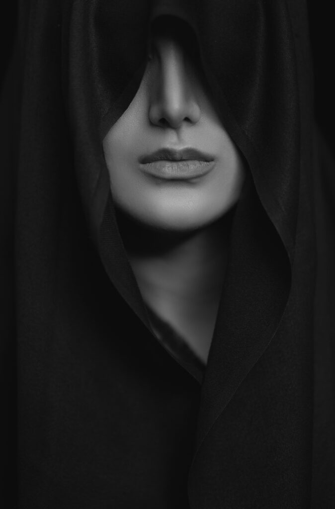 Beautiful woman using a black silk shawl to guard her eyes...representing the power to protect your mind from the pitfalls of the world.